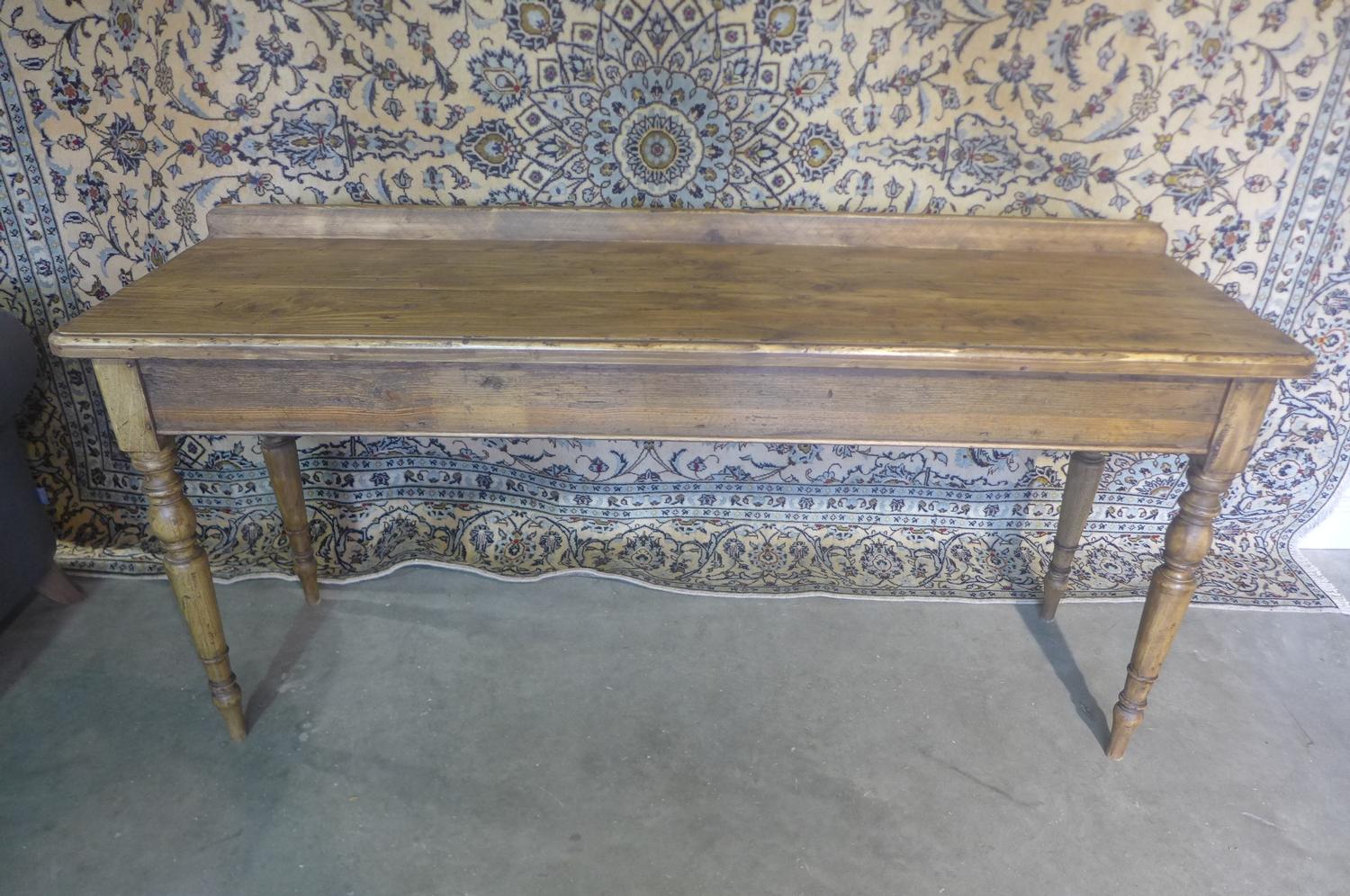 A rustic pine serving table on turned legs, 89cm tall