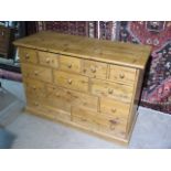 A stripped pine thirteen drawer merchants chest, made from old timbers, 84cm tall x 120cm x 48cm