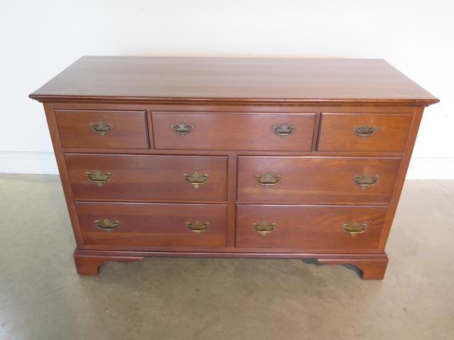 A 20th Century reproduction seven drawer chest, 133cm wide x 82cm H