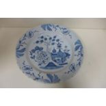 A Delft ware plate, 30cm diameter, fritting to edge and crazing but generally good