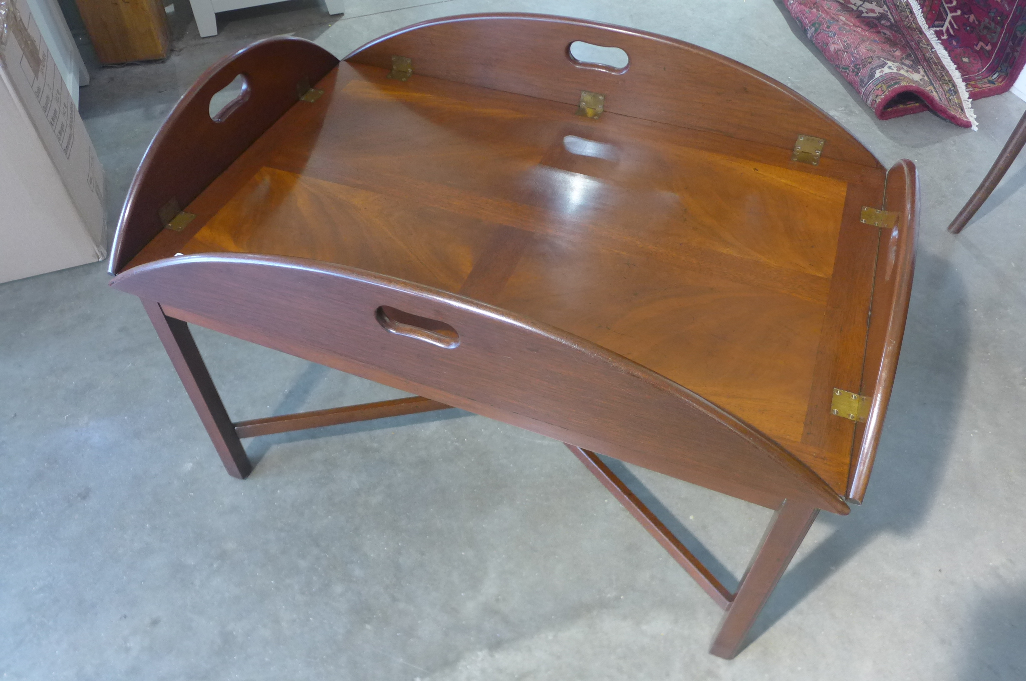 A mahogany butlers tray on stand on the form of a coffee table, 63cm H x 93cm x 62cm closed