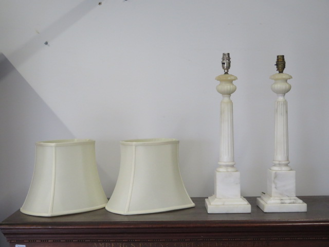 A pair of white marble table lamps, 52cm tall, and a pair of shades, shades need fittings