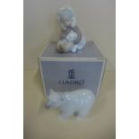 A Lladro Eskimo boy and polar bear, boxed - and a Lladro polar bear - both good