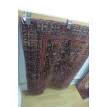 A hand knotted woollen Baluchi rug - 115cm x 86cm