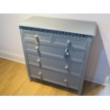 A decorative chest of drawers with two short over three long drawers, with china handles recently
