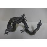 A bronze dragon stand, 33cm long, some casting faults, otherwise good