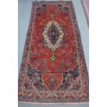 A hand knotted woollen Hamadan rug - 303cm x 141cm