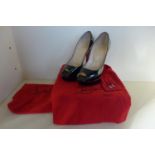 A pair of Christian LeBoutin lady peep toe patent calf black ladies high heel shoes, size 40.5, with