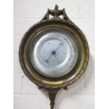 A gilt aneroid wall barometer, 38cm tall