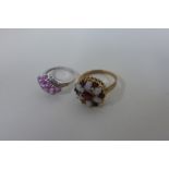 A hallmarked 9ct gold opal and garnet ring, size P, one opal split, and a 9ct white gold ring,