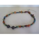 A multi stone and metal tribal necklace, approx 94cm long