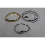 A white metal Neillo snake bangle, a hallmarked silver bangle and another snake bangle marked