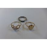 A hallmarked 9ct diamond ring, a hallmarked 9ct diamond ring and a white metal diamond and