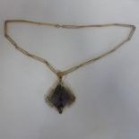 An interesting 9ct hallmarked gold amethyst pendant on a chain, pendant measures 7x5cm, approx 23