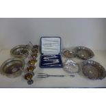 Two pairs of silver plated bottle coasters, two plated shell dishes, a boxed nut cracker set and