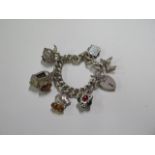 A large silver charm bracelet with various charms, approx 3.2 troy oz