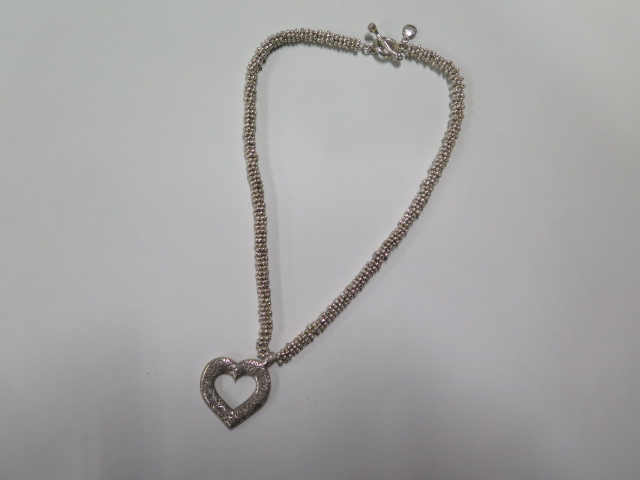A silver Dower and Hall necklace consisting of multi bead links and large engraved heart pendant -