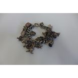 A heavy silver charm bracelet with various charms, approx 27 - approx 3.7 troy oz