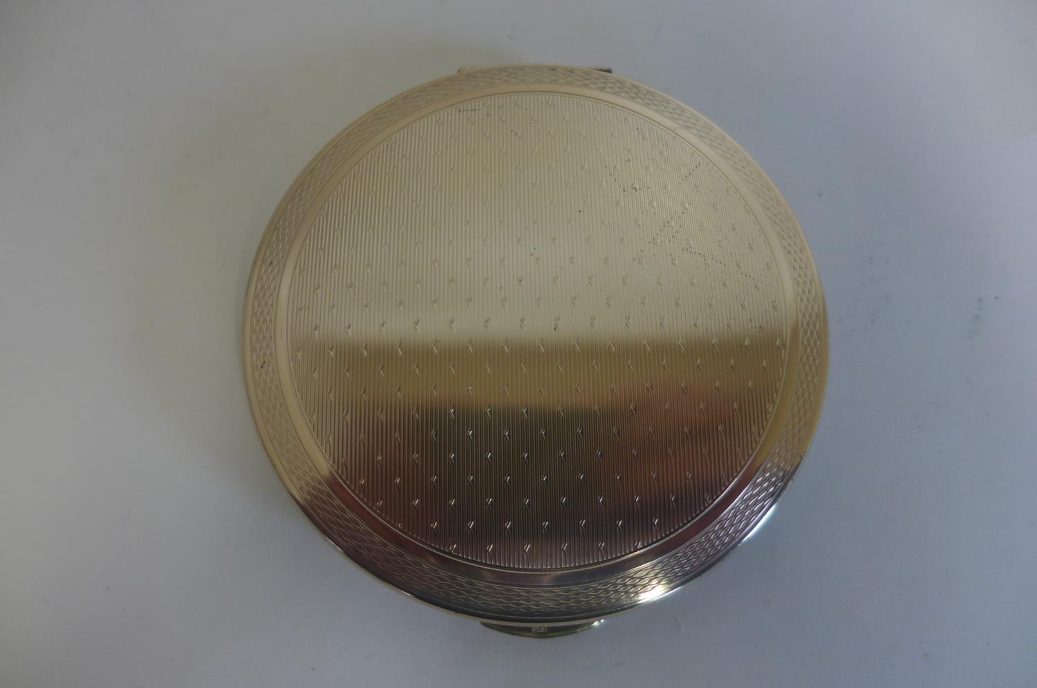 A silver compact by Kigu of London, in good condition, 7cm diameter