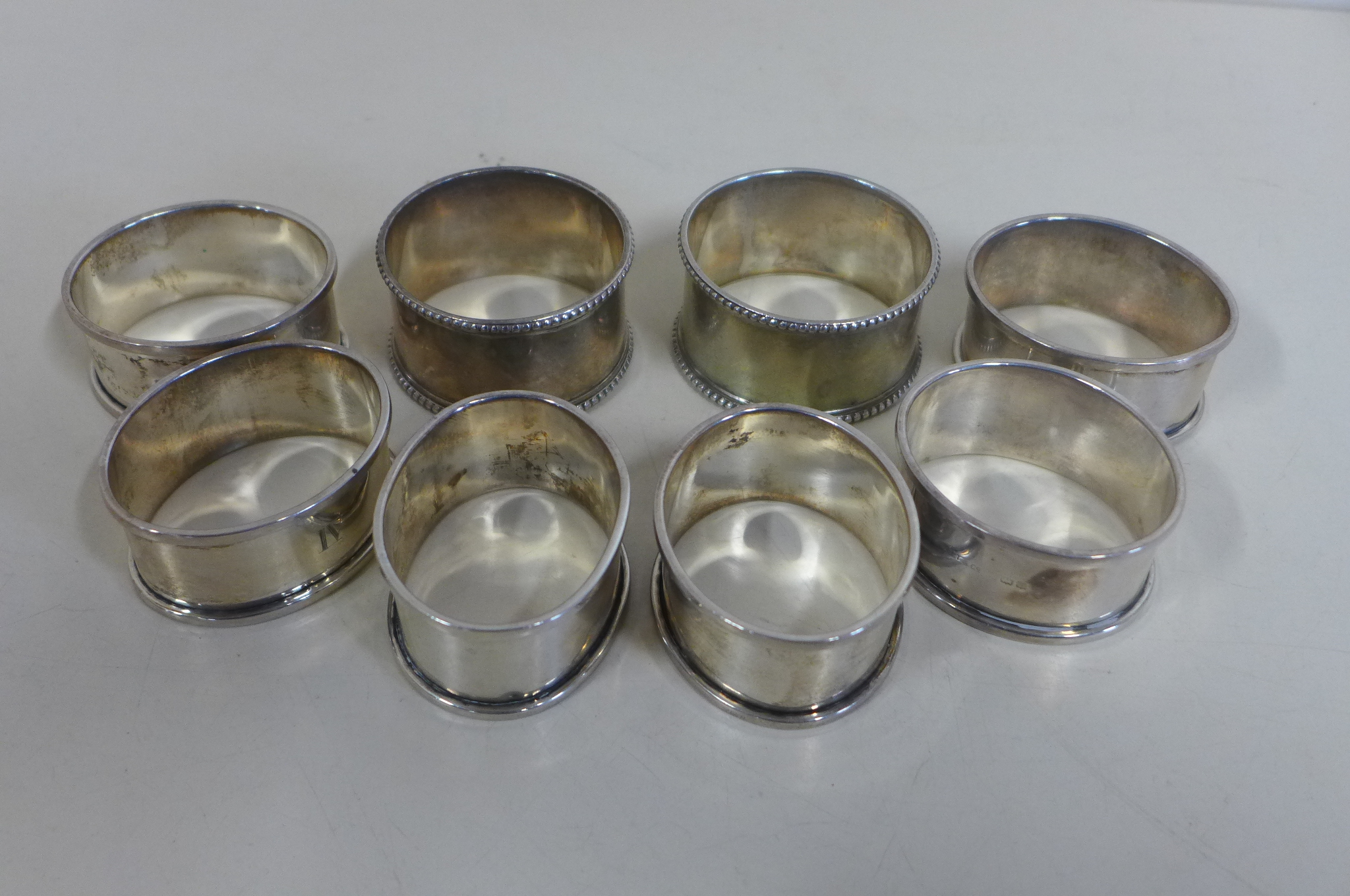 Six silver napkin rings, and a pair of napkin rings, approx 3.4 troy oz