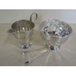 A silver milk jug, sugar bowl and nips, total weight approx 9.7 troy oz, some usage marks but