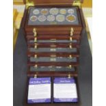 A British coins of WWII cased set, housed in an eight drawer cabinet with certificates