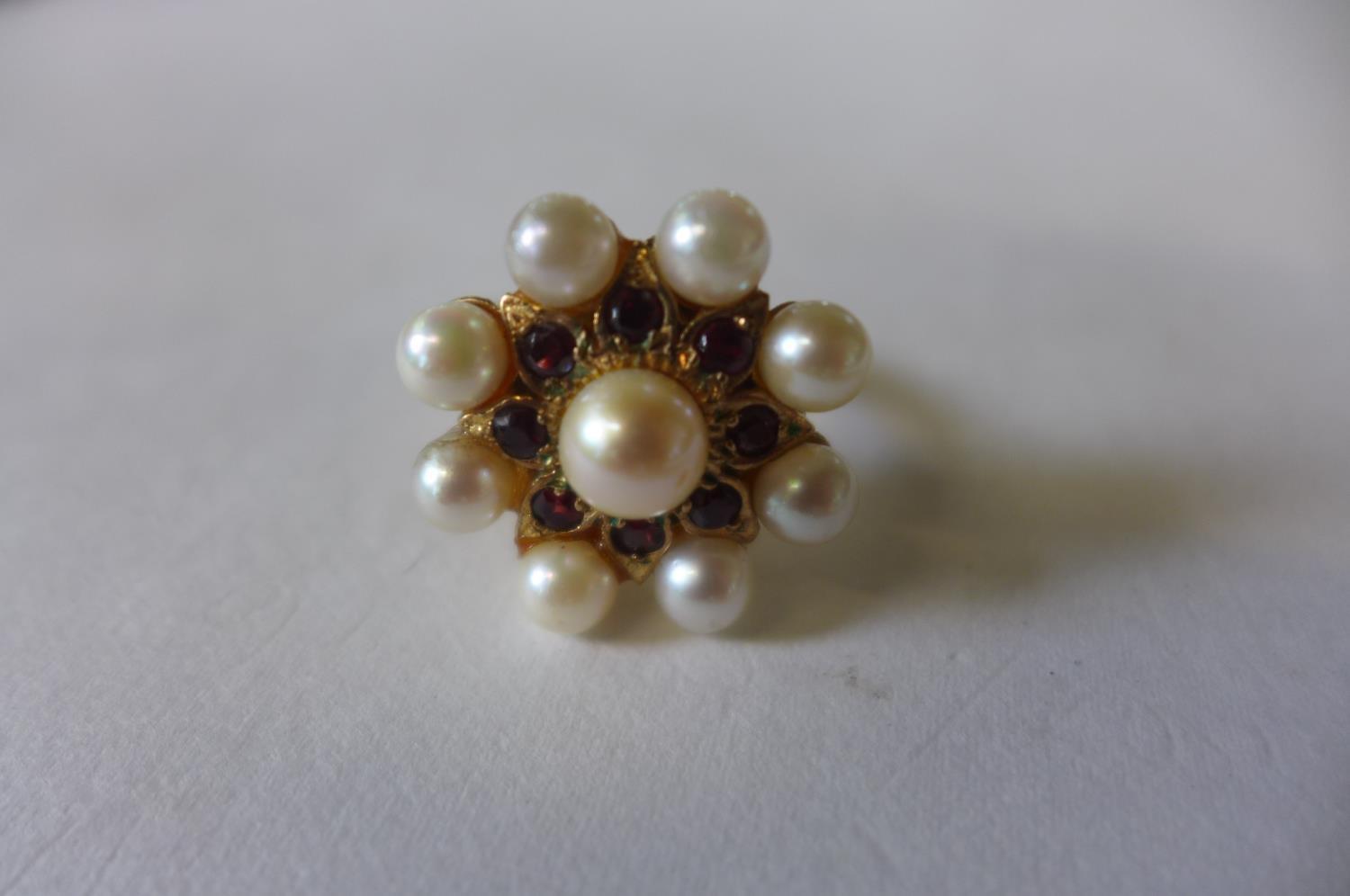 A 9ct gold pearl and garnet ring converted from a clasp, head is 2cm diameter, ring size O, approx