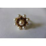 A 9ct gold pearl and garnet ring converted from a clasp, head is 2cm diameter, ring size O, approx