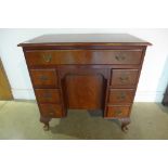 A Georgian style mahogany kneehole seven drawer desk, 77cm tall, 78x46cm
