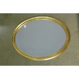 A modern gilt oval mirror, 78cm x 58cm