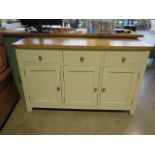 An ex-display painted ivory three door sideboard - 139cm W x 47cm D x 88cm H