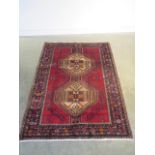 A hand knotted woollen Afshar rug - 230cm x 161cm