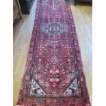 A hand knotted woollen Hamadan rug 315x100cm