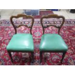 A pair of 19th century mahogany side chairs with green leather seats