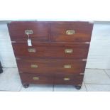 A Victorian teak two part military or campaign chest of drawers with two short drawers over three