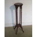 A modern mahogany plant stand, 101cm tall x 26cm diameter