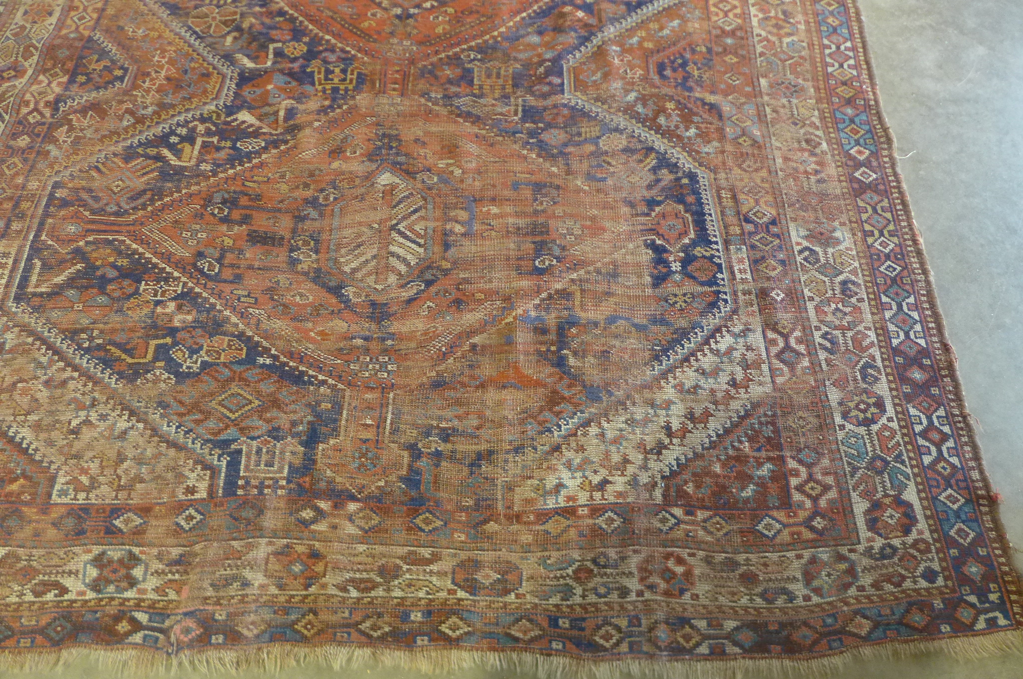 A vintage hand knotted Eastern woollen rug, 302cm x 206cm, in worn condition and some fading - Image 2 of 8