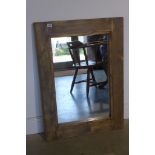 A pine framed rustic style mirror, measures 90x66cm