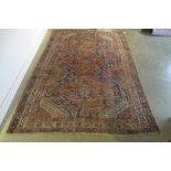 A vintage hand knotted Eastern woollen rug, 302cm x 206cm, in worn condition and some fading