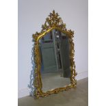 A modern ornate gilt mirror, 143cm x 80cm