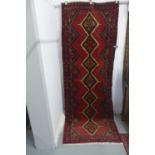 A hand knotted woollen Hamadan rug - 274x106cm