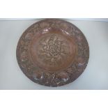 An Arts and Crafts copper embossed dish dated 1906 - 34cm diameter, generally good, no cracks