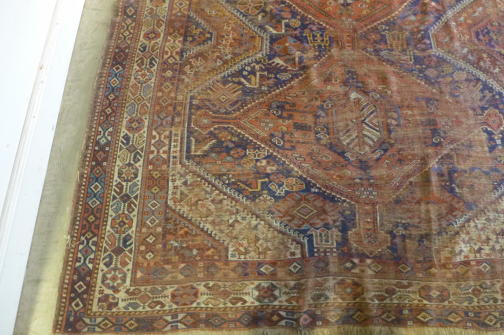 A vintage hand knotted Eastern woollen rug, 302cm x 206cm, in worn condition and some fading - Image 3 of 8