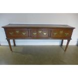 An 18th century oak three drawer dresser base on turned supports, 81cm H x 190cm x 43cm - with