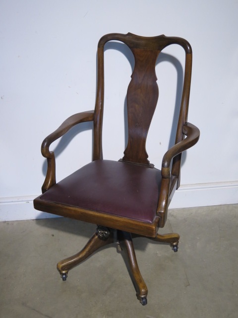 A 1920s walnut desk chair