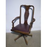 A 1920s walnut desk chair