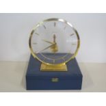 A Jaeger-leCoultre mystery clock with gilt case and baton markers, 19cm tall with original box,