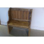 A small rustic pine pew with panel back, length 80cm, back height 90cm, seat height 45cm, depth 42cm