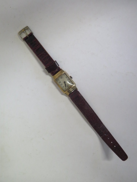 A gents vintage 9ct gold tank watch, Art Deco style case with off white dial, Arabic numerals and