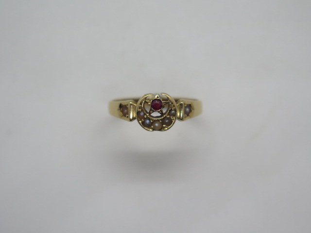 A Victorian 18ct gold garnet and seed pearl ring in a star and crescent setting, stamped 18ct and